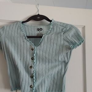 A light blue, v neck top